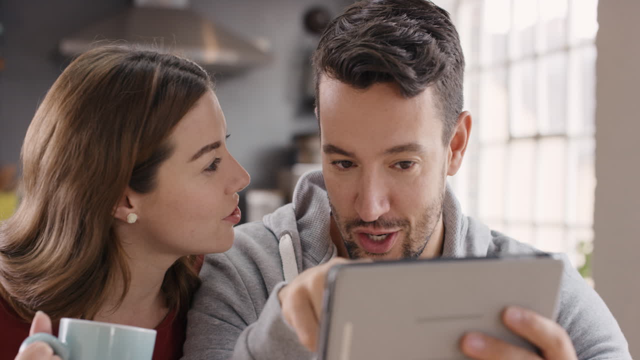 pareja feliz usando una tableta digital en casa pasando tiempo juntos