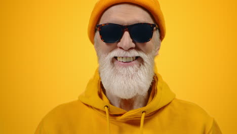 happy aged man posing in studio. cheerful mature gentleman smiling indoors.