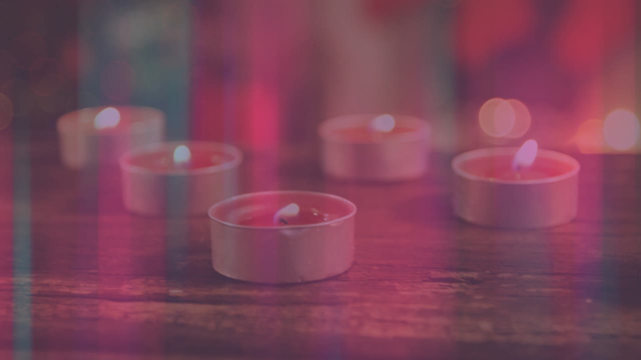 Central candle igniting melting wax while candles flickering and lights cycling hues for calm mood