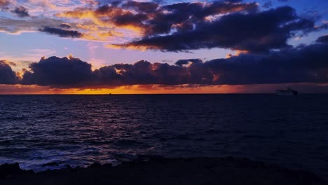 time lapse of marvelous seascape at sunset time, boats cruising in tenerife island, canary, spain