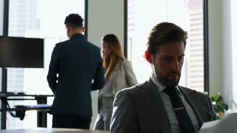 businessman looking at documents in office 4k