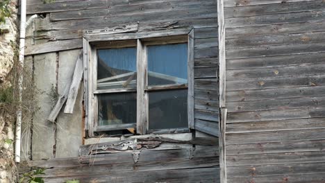 old abandoned wooden house with broken window