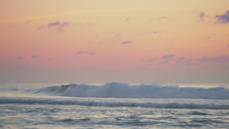 a person surfing waves at dusk