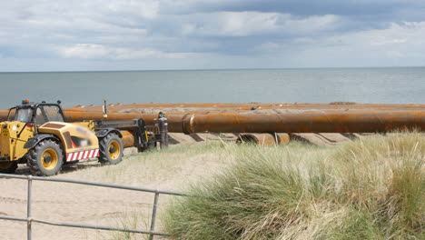 Coastal-construction-oil-gas-and-water-pipeline-pipes-on-the-beach