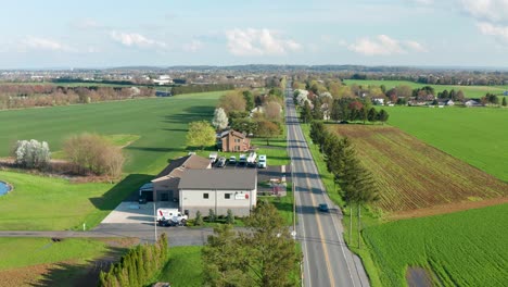 aerial of long straight road in rural america, usa during spring