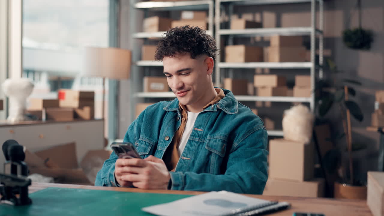 Man using phone with boxes in the background