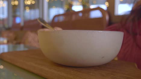 woman eating from a bowl in a restaurant