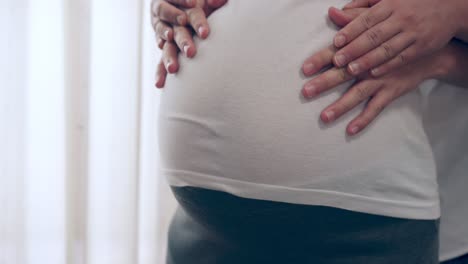 pregnant couple feels love and relax at home.