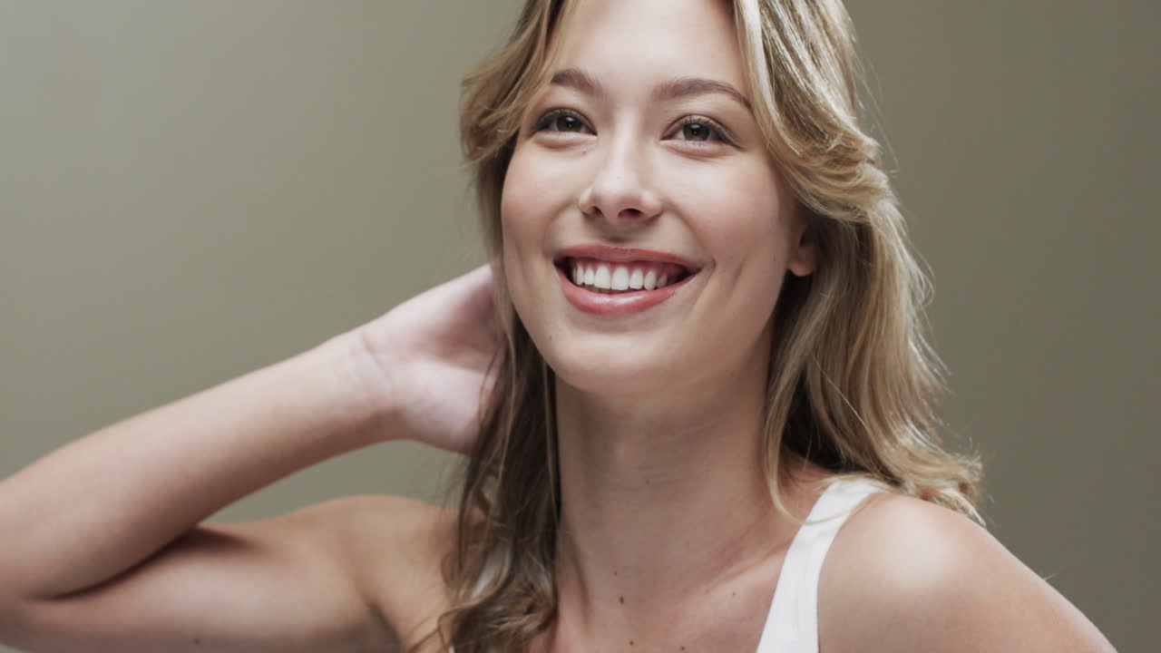 Portrait of smiling caucasian woman with blond hair, copy space, slow motion