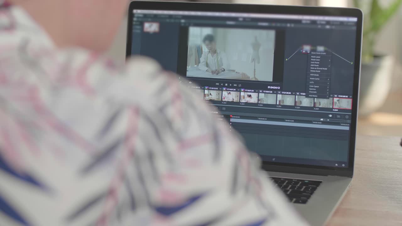 Man Works In Video Editing App / Software On His Laptop Computer