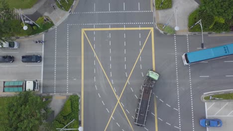 drone-filming-an-intersection-with-cars-driving---turning