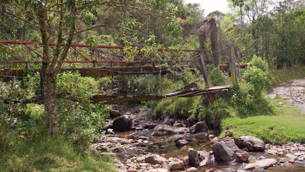Suspension bridge over creek river in Cocora Valley national park Colombia nature