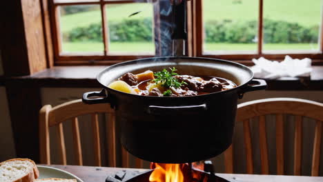 steaming hearty beef stew on a wooden table