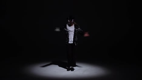 michael jackson impersonator dancing in a spotlight