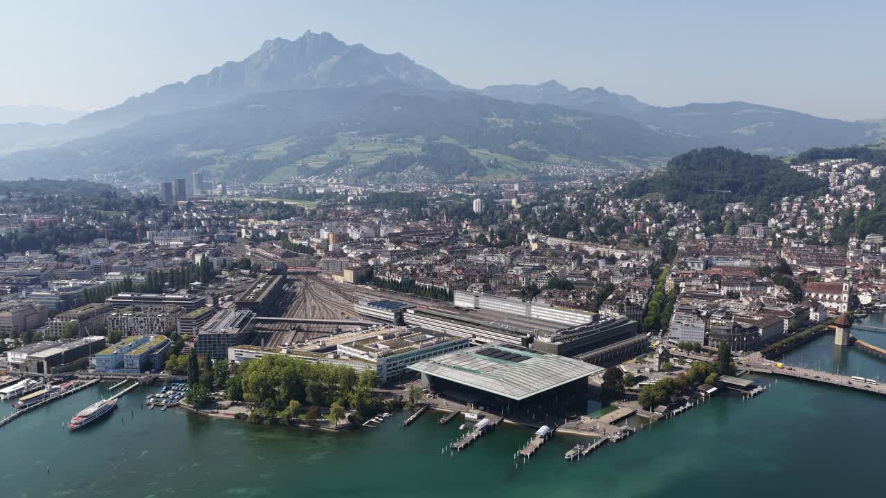 Lucerne (Switzerland) aerial drone video focused on the central station, university, Bahnhofstrasse, and boulevar