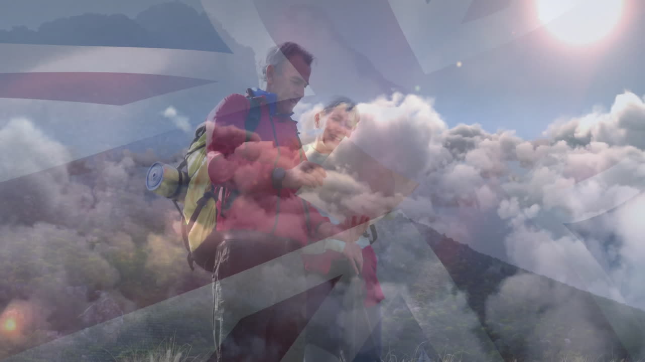 Mature hikers studying map on mountain ridge, showing health icons, Union Jack overlay, sun rays