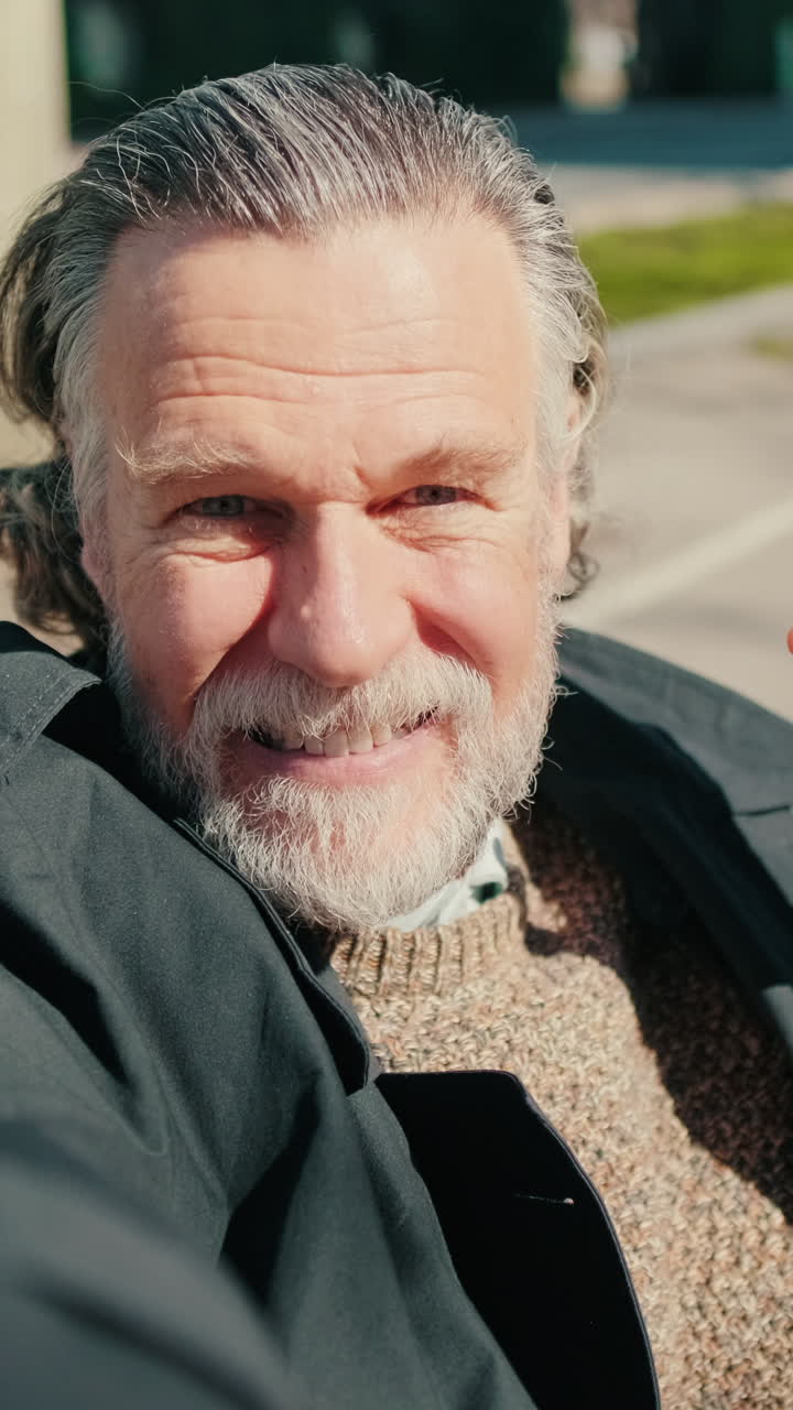 Happy Senior Man Waves in Selfie Video