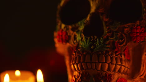 cerca de la naturaleza muerta de cráneos decorados iluminados por velas celebrando la fiesta mexicana de dia de muertos o día de los muertos 8