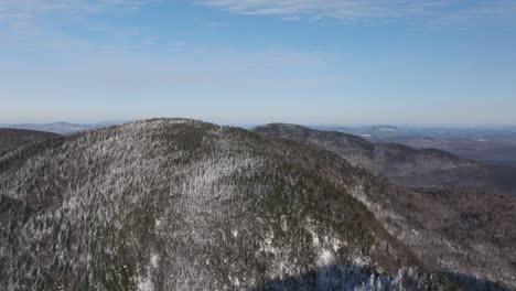 hills and mountains with winter forest in eastern quebec, canada