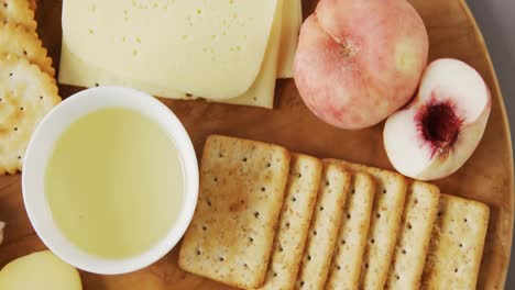 different types of cheese with crispy biscuits, fruits and sauce