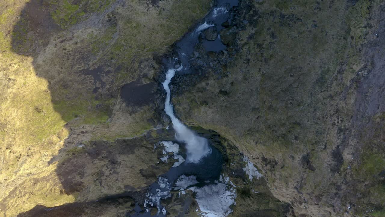 Flying towards a waterfall in Iceland looking straight down.
