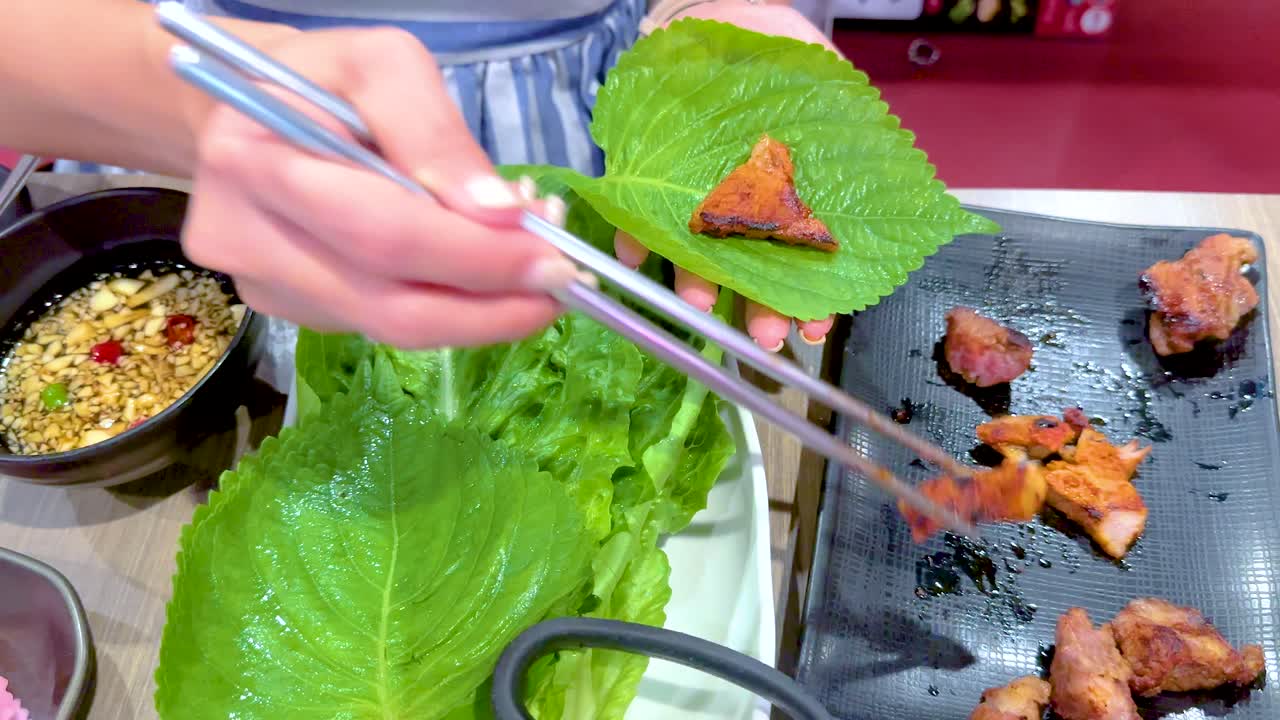 Eating Grilled Pork with Lettuce Wraps