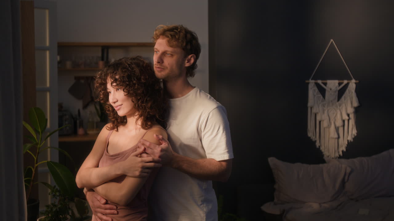 A loving couple embracing in a cozy setting