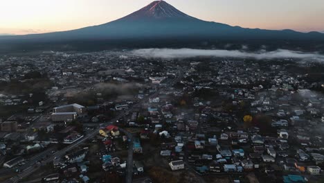 Aerial-view-of-a-urban-landscape-with-Mt-Fuji-in-the-background,-foggy-sunrise-in-Japan