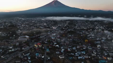 aerial view of a urban landscape with mt fuji in the background, foggy sunrise in japan