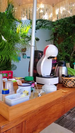 coffee time. table set with modern capsule coffee machine with accessories