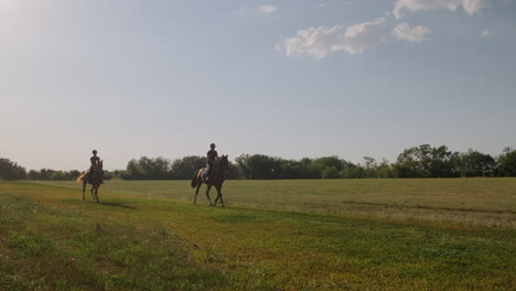 two horseback riders in a field