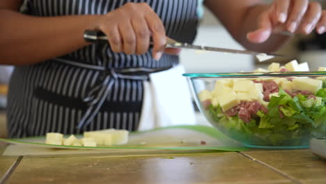 dicing cheese to add to the chopped salad - antipasto salad series