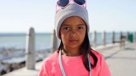 Child,-face-and-fashion-at-beach-promenade