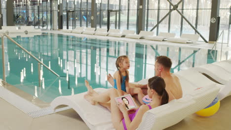 family enjoying a video call by the pool