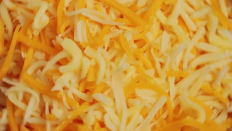 some different sorts of grate cheese on plate close up macro. chef grating cheese mozzarella, cheddar for meals. itallian food, pizza, pasta. high quality 4k footage