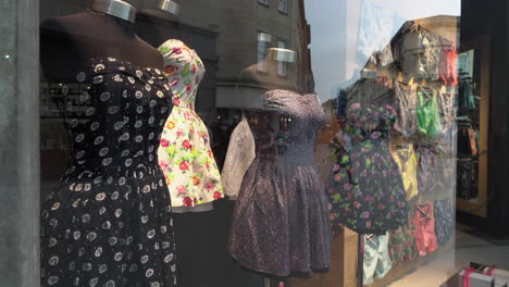 dresses on mannequins in a shop window display