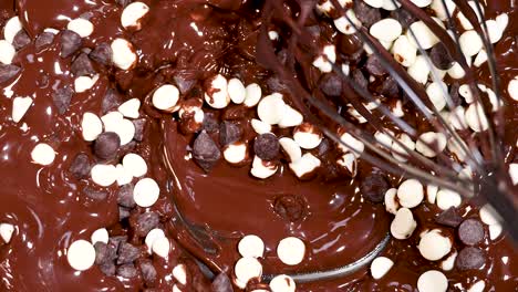 whisking chocolate chips into melted chocolate