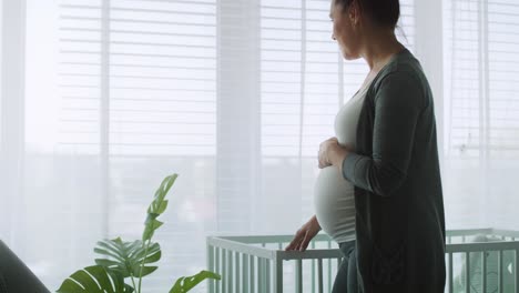 mid-shot video of pensive future mom in bedroom.