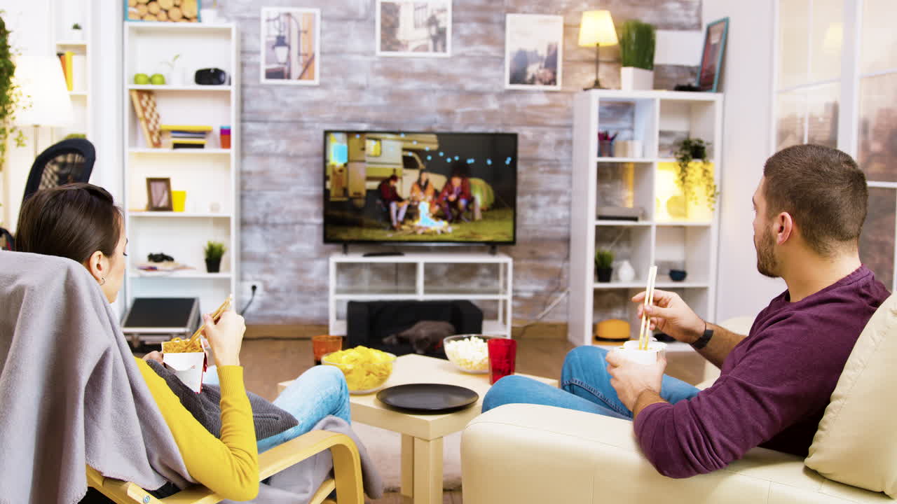 Couple Enjoying Takeout and TV in Living Room