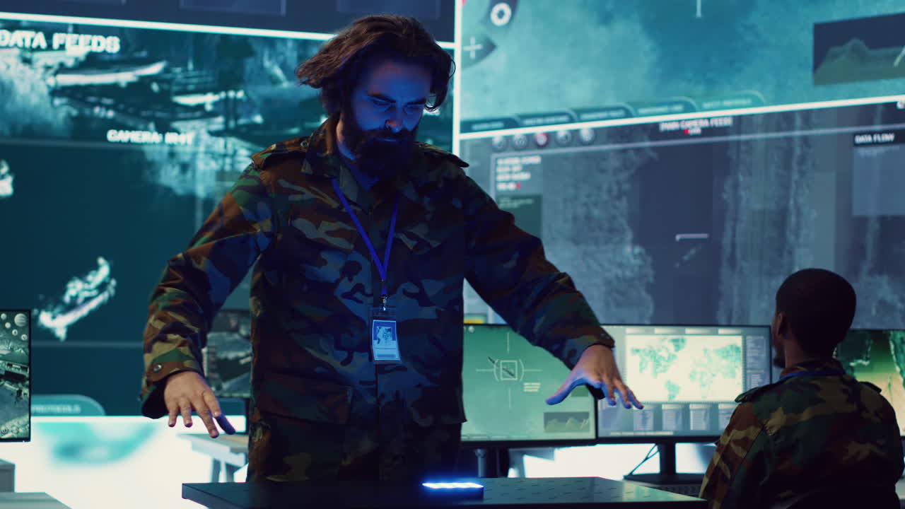 Infantry unit leader studies satellite imagery on a holographic image