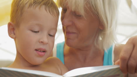 grandmother reading a book to grandson