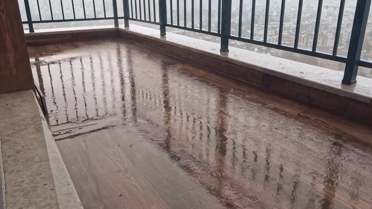 Rain Falling on a Wooden Balcony Floor