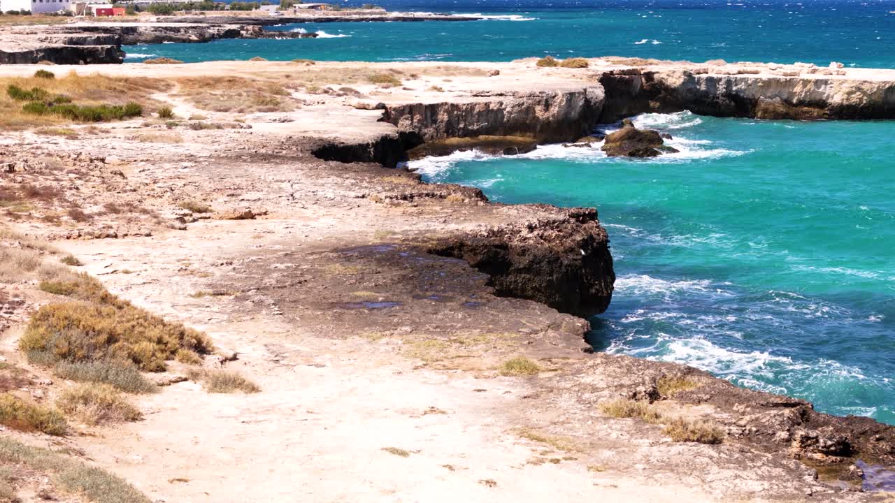Splashing sea waves and rocky Italian shore, aerial low angle view