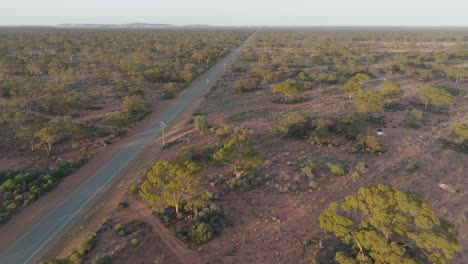 drone clip showing long straight road for direct shipping through remote australian outback