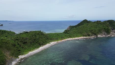 Tropical-Beach-In-The-Green-Island-With-Calm-Sea-In-Summer