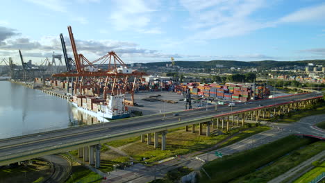 Driving-Vehicles-On-Flyover-Next-To-Dockyard-Of-Gdynia-Seaport-In-Gdansk-Bay-At-Baltic-Sea,-Poland