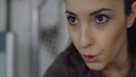Handheld video of young woman working out with exercise bike