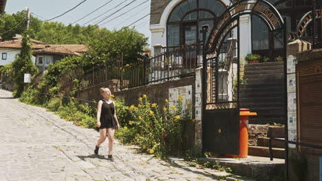 young female summer tourist walks old streets of veliko tarnovo bulgaria