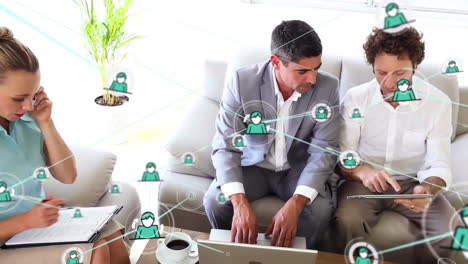 animation of network of people icons over diverse colleagues using tablet and phone at casual office