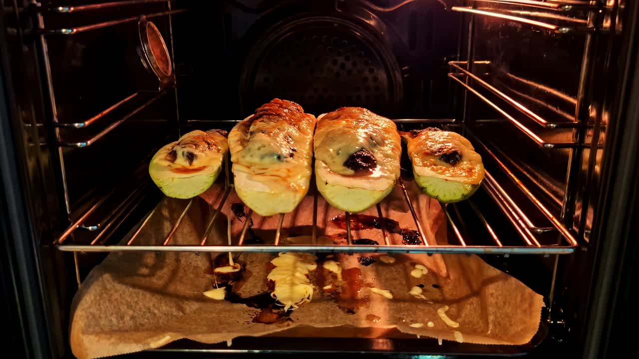 Stuffed zucchini baking in an oven, warm kitchen ambience